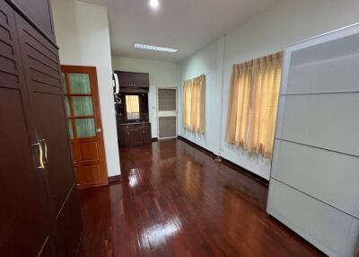 Spacious bedroom with wooden flooring and ample storage