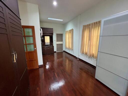 Spacious bedroom with wooden flooring and ample storage