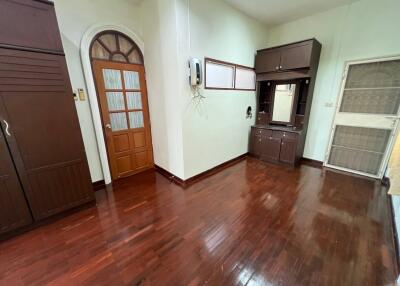 Spacious bedroom with wooden floors and built-in cabinets