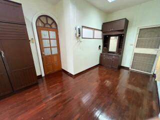 Spacious bedroom with wooden floors and built-in cabinets