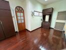 Spacious bedroom with wooden floors and built-in cabinets