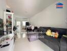 Spacious living room area with a modern couch and children's toys.