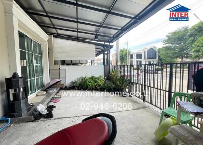 Outdoor porch area of a building with surrounding neighborhood view