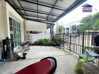 Outdoor porch area of a building with surrounding neighborhood view