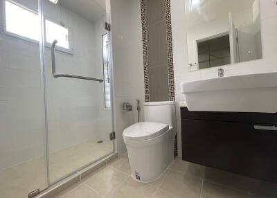 Modern bathroom with glass shower enclosure and vanity