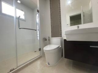 Modern bathroom with glass shower enclosure and vanity