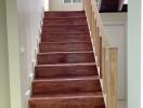 Interior view of a staircase with wooden steps and railing