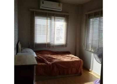 Bedroom with bed, dresser, air conditioning, and window blinds with natural light