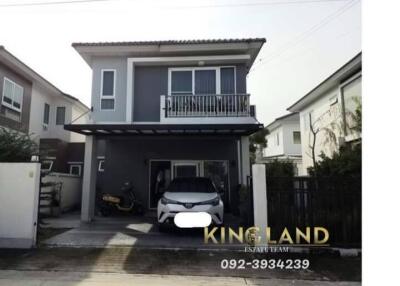 Two-story house with a carport and balcony