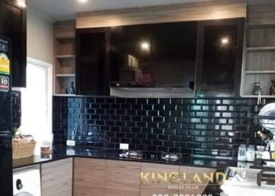 Modern kitchen with wooden cabinets and black tile backsplash