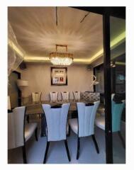 Elegant dining room with chandelier and upholstered chairs