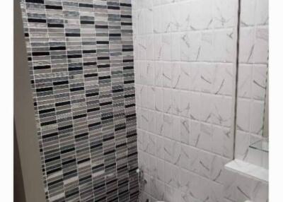 Modern bathroom with tiled walls