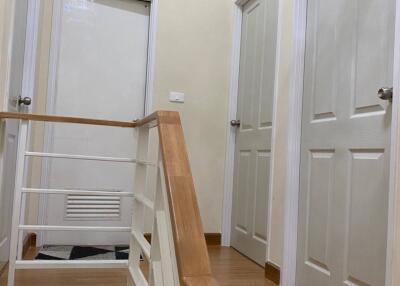 Hallway with wooden floor and white doors