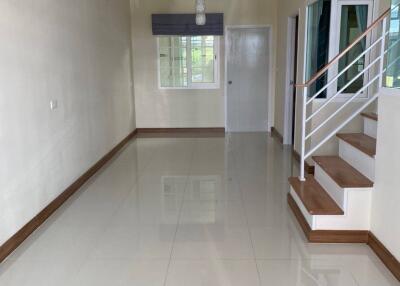 Living room with stairs and large tiled floor