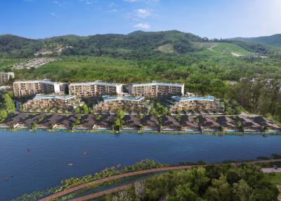 Aerial view of a resort with multiple buildings and villas surrounded by greenery and water