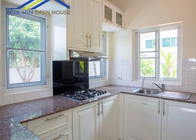 Modern kitchen with granite countertops and white cabinets