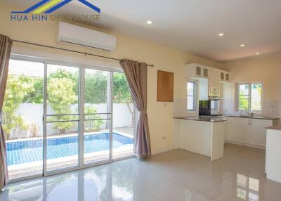 Living area with kitchen and access to pool