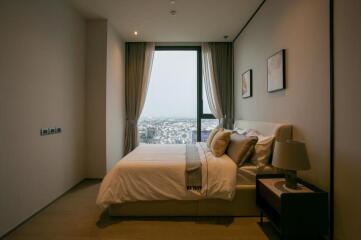 Modern bedroom with a large window and city view