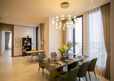 Modern dining room with chandelier and large windows