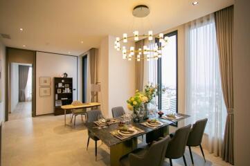 Modern dining room with chandelier and large windows