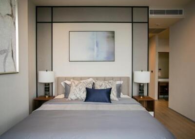 Modern bedroom with double bed, bedside tables, and wall art