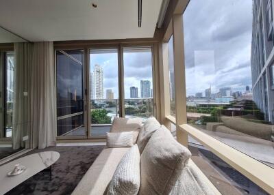 Spacious living room with large windows and city view