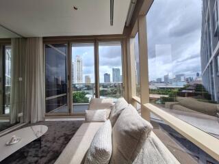 Spacious living room with large windows and city view