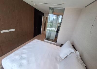 Modern bedroom with a large bed and an en suite bathroom