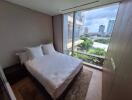 Modern bedroom with large windows and city view