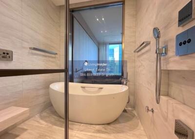 Modern bathroom with a freestanding bathtub and glass shower enclosure