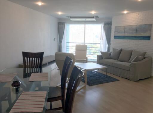 Living room with dining area and large window