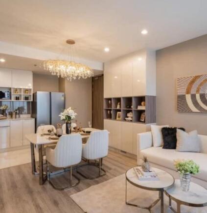 Modern living and dining area with chandelier