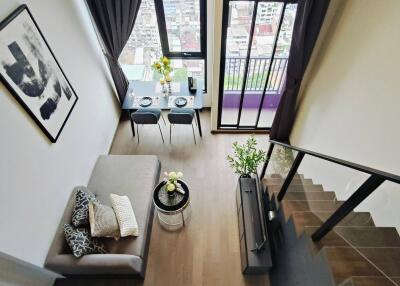 Modern living room with a dining area and large windows