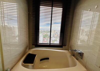 Contemporary bathroom with tub and city view