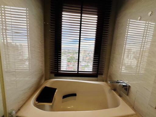 Contemporary bathroom with tub and city view