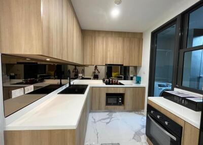 Modern kitchen with wooden cabinets and white countertops