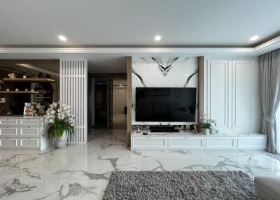 Modern living room with marble flooring and large TV