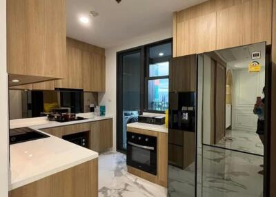 Modern kitchen with wood cabinets and marble flooring