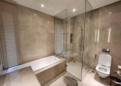 Modern bathroom with bathtub, shower, and toilet