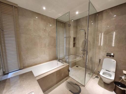 Modern bathroom with bathtub, shower, and toilet