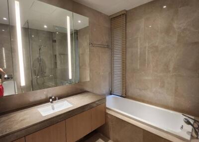 Modern bathroom with sink, bathtub, and large mirror