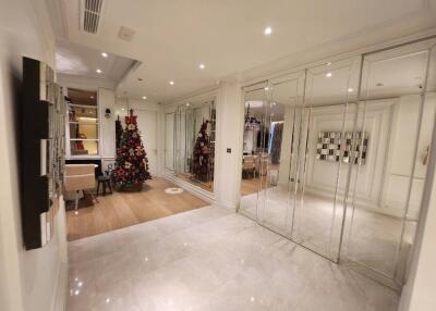 Spacious living area with festive decor and mirrored wall