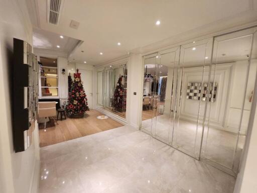 Spacious living area with festive decor and mirrored wall