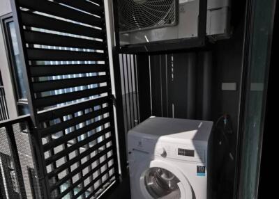 Laundry area with washing machine and air conditioning unit