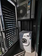 Laundry area with washing machine and air conditioning unit