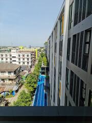 View of residential building from a higher floor with a swimming pool and surrounding structures