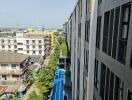 View of residential building from a higher floor with a swimming pool and surrounding structures