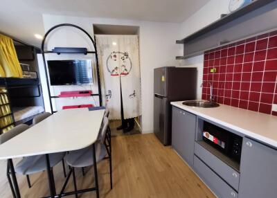 Modern kitchen area with dining table and appliances