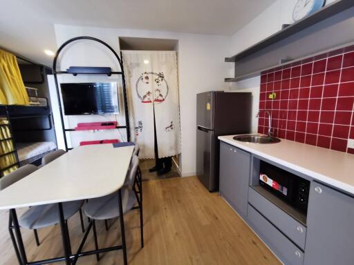 Modern kitchen area with dining table and appliances