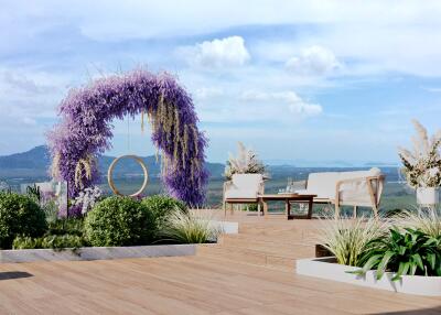 Rooftop terrace with scenic view, floral arch, and seating arrangement